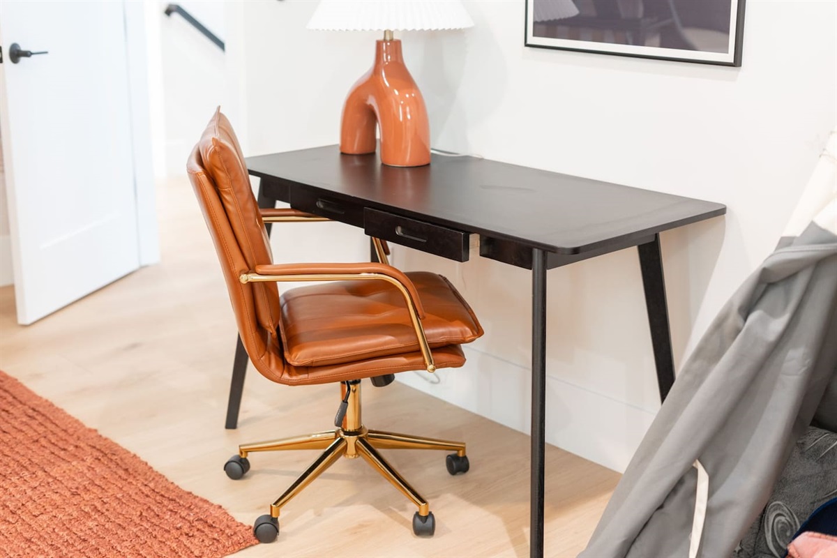 Stylish workspace with a sleek desk and leather chair, perfect for work or study.