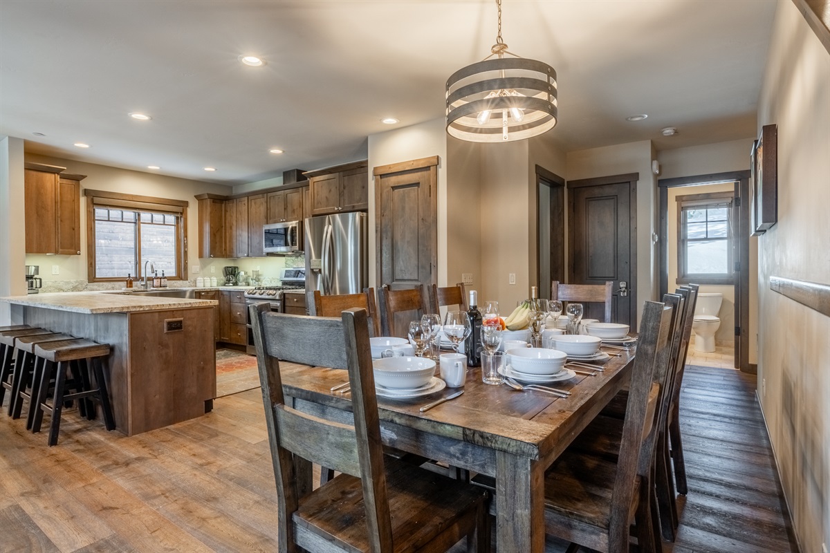 Gather around the Triple Black table with mountain light and easy flow between kitchen and living spaces.
