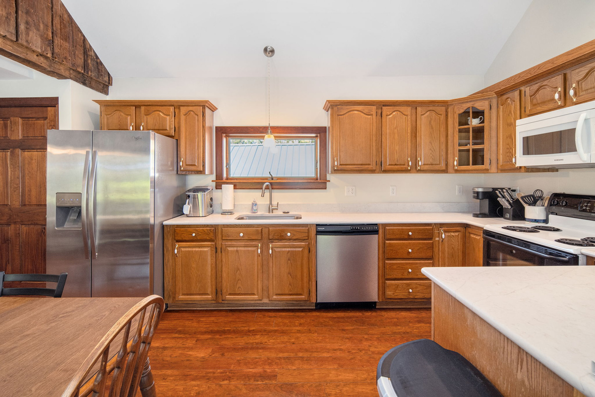 Wood cabinetry and modern appliances complement the home's rustic character.