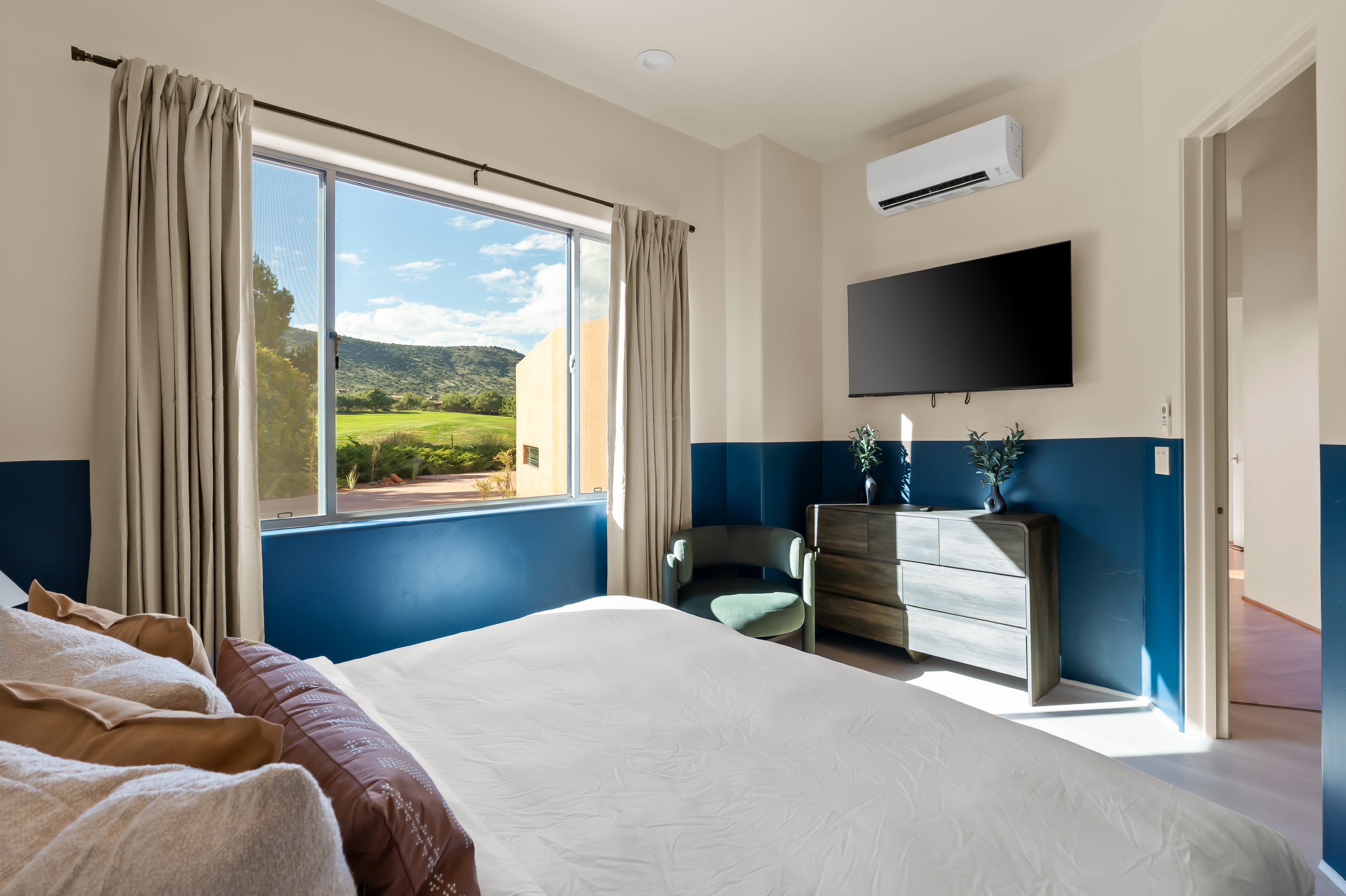Wake up to direct golf course views and scenic mountain vistas, featuring a large smart TV and custom mini-split climate control.