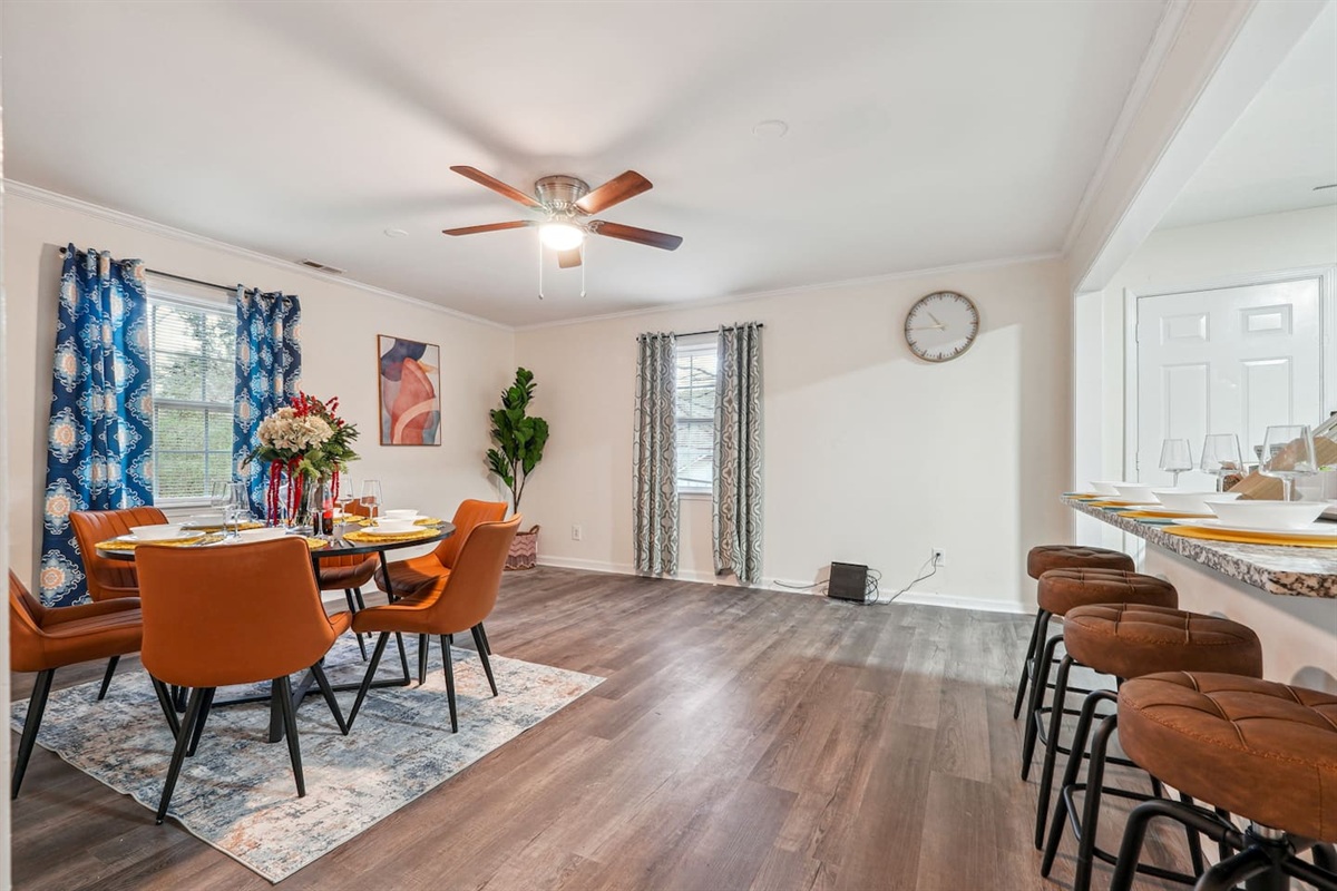 A dining area featuring a dining table set and a bar counter with four bar chairs — perfect for enjoying meals or casual drinks.
