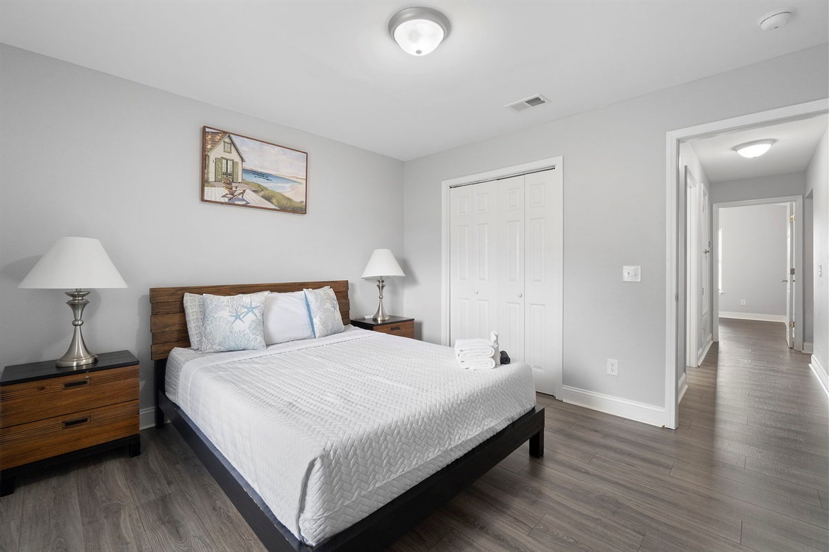 Unwind in comfort in this beautifully appointed guest bedroom featuring contemporary furnishings, elegant lamps, and plenty of natural light. A spacious closet and modern ceiling fan complete the space, making it ideal for both short and extended stays.