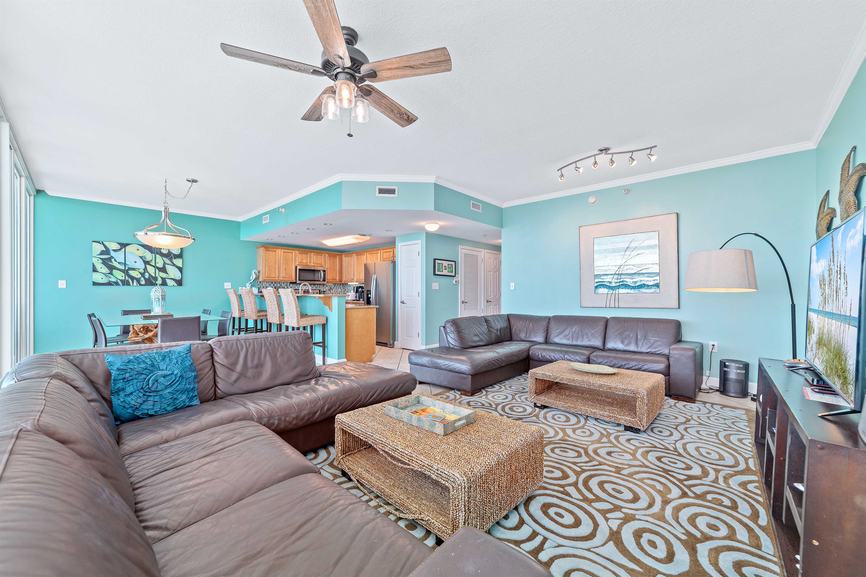 This well-appointed living space offers a comfortable sectional sofa, elegant coffee table, and a dining area with seating for six, creating a welcoming atmosphere.