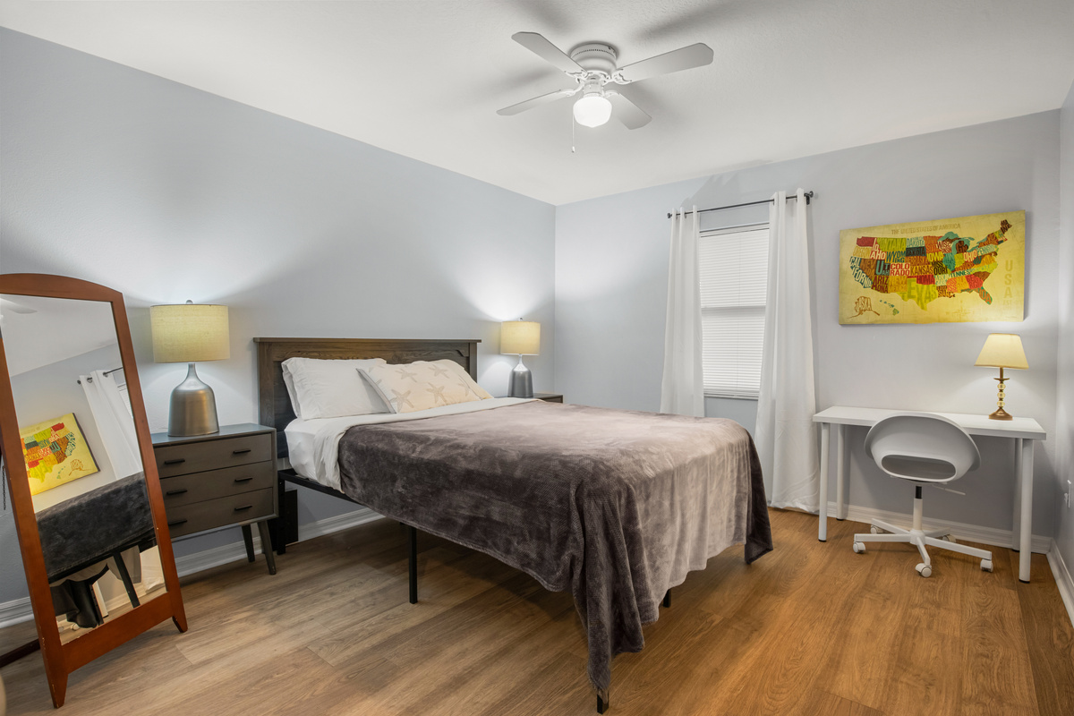 Primary bedroom includes an office desk ad chair.