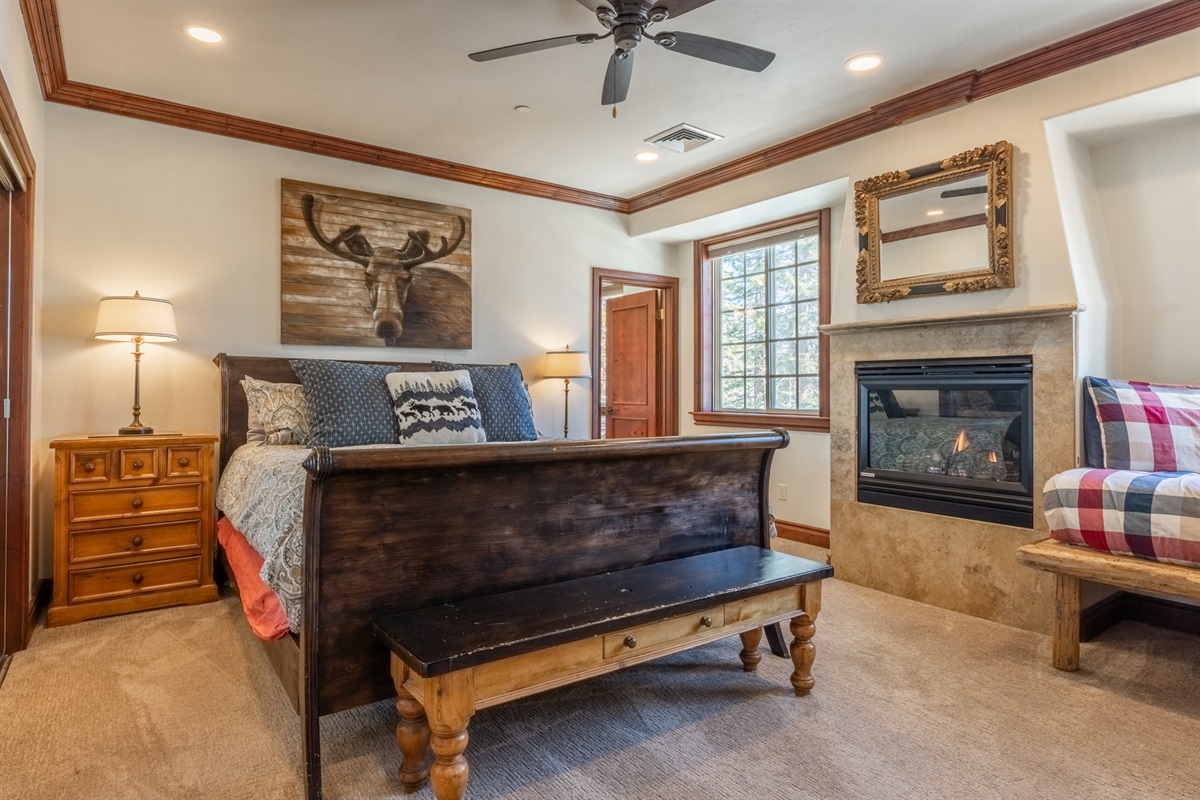 Primary suite in the Moose offers a king bed, gas fireplace, daybed, and ensuite bath—designed as a calm, private retreat within the home.