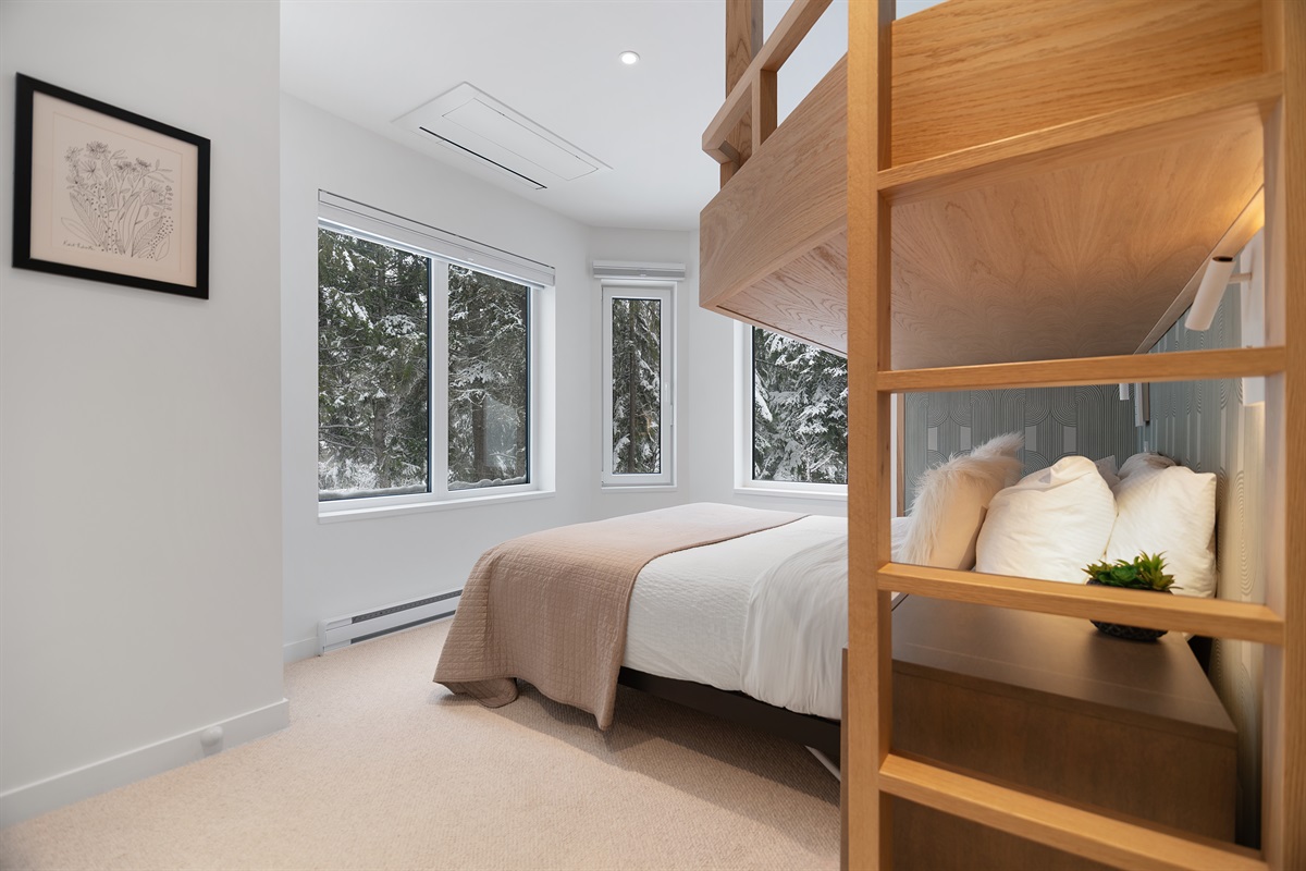Bedroom #3 offers immersive mountains, river & forest views  Overlooking Fitzsimmons Creek, open a window to hear sounds of the glacier fed creek. Queen bed +  custom built-in Oak Twin XL bunk.   Closet organizer.