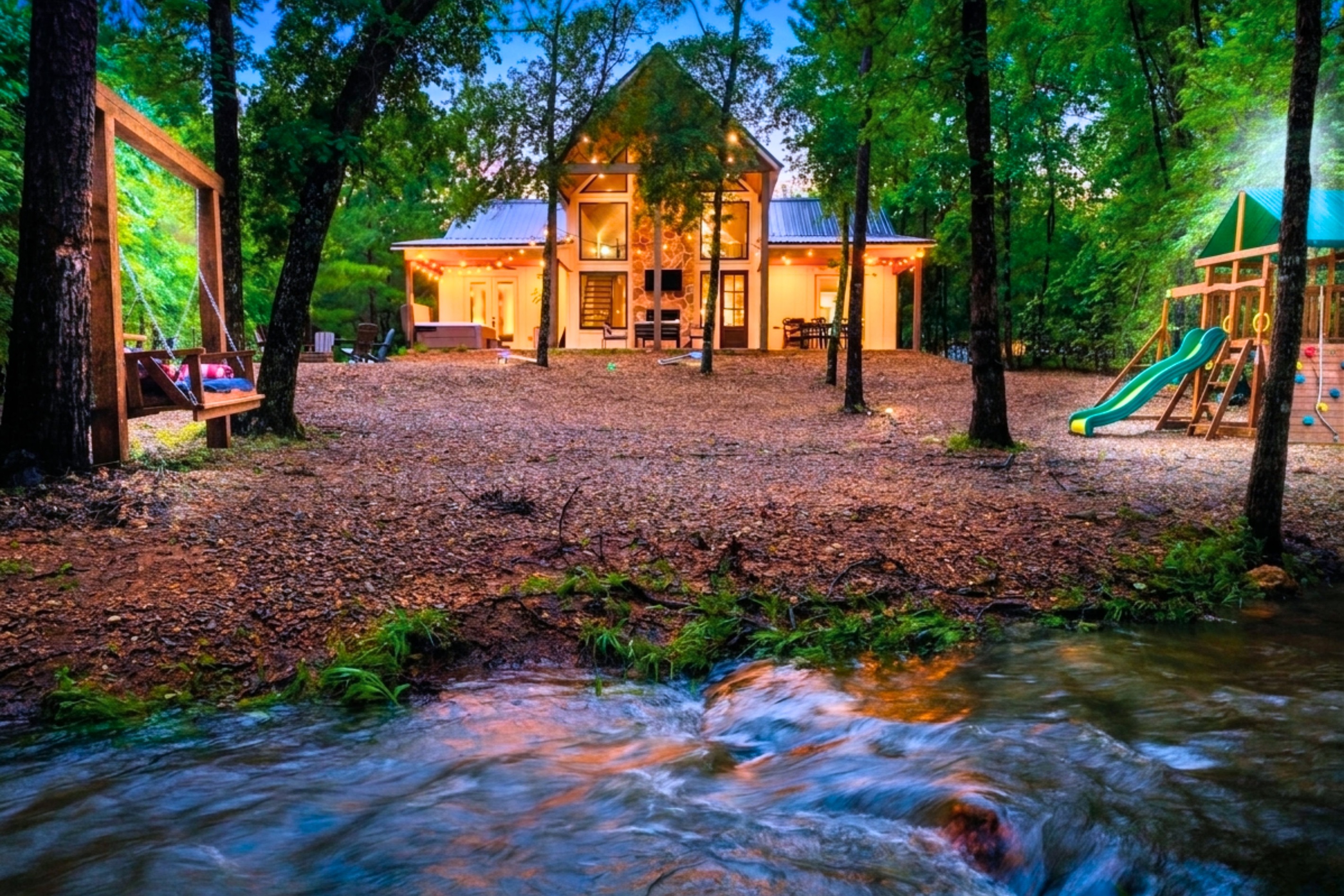 Welcome to your serene getaway in Hochatown! With a seasonal creek, swing daybed, playset, and hot tub in your own private backyard