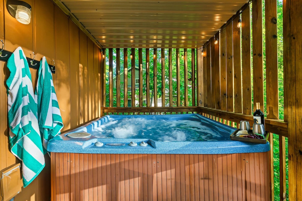 Unwind in the private hot tub, on the main level covered porch
