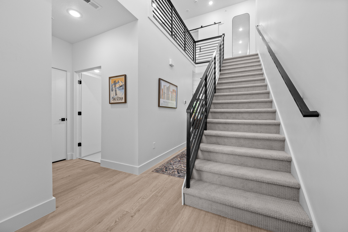 Stairway leading to the second-floor bunk room and ensuite bathroom.