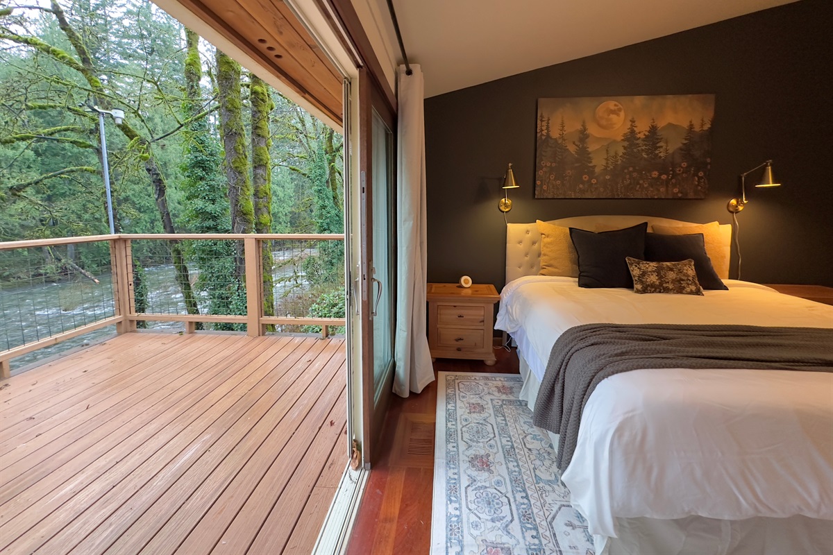 The primary suite upstairs is perched just above the Salmon River. Wake up and walk onto the large sundeck overlooking the river, or crack the large sliding glass door open & fall asleep to the sounds of the water.  