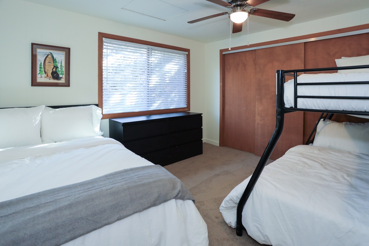 Bedroom 2 has a cozy double bed and a bunk bed with double/twin combo. Ceiling fan.