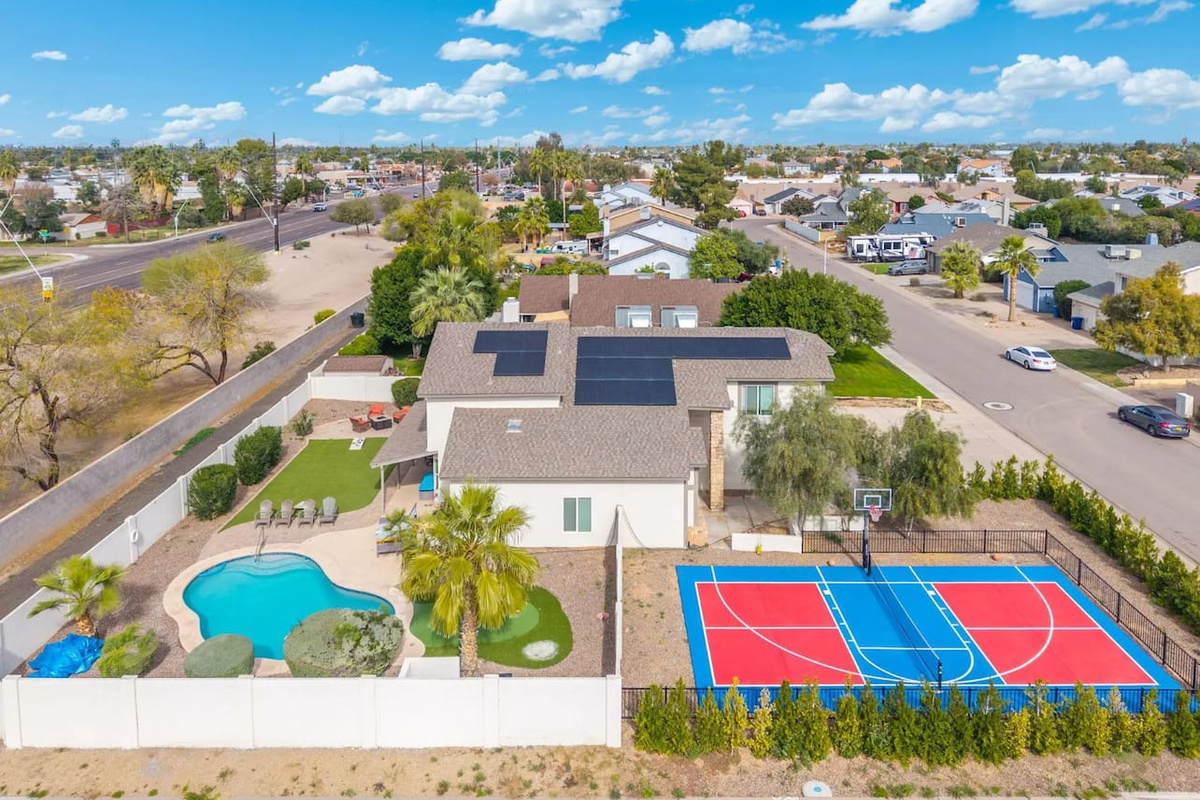 Luxury estate with resort pool, sports courts, solar panels, and sprawling grounds—the ultimate group retreat.
