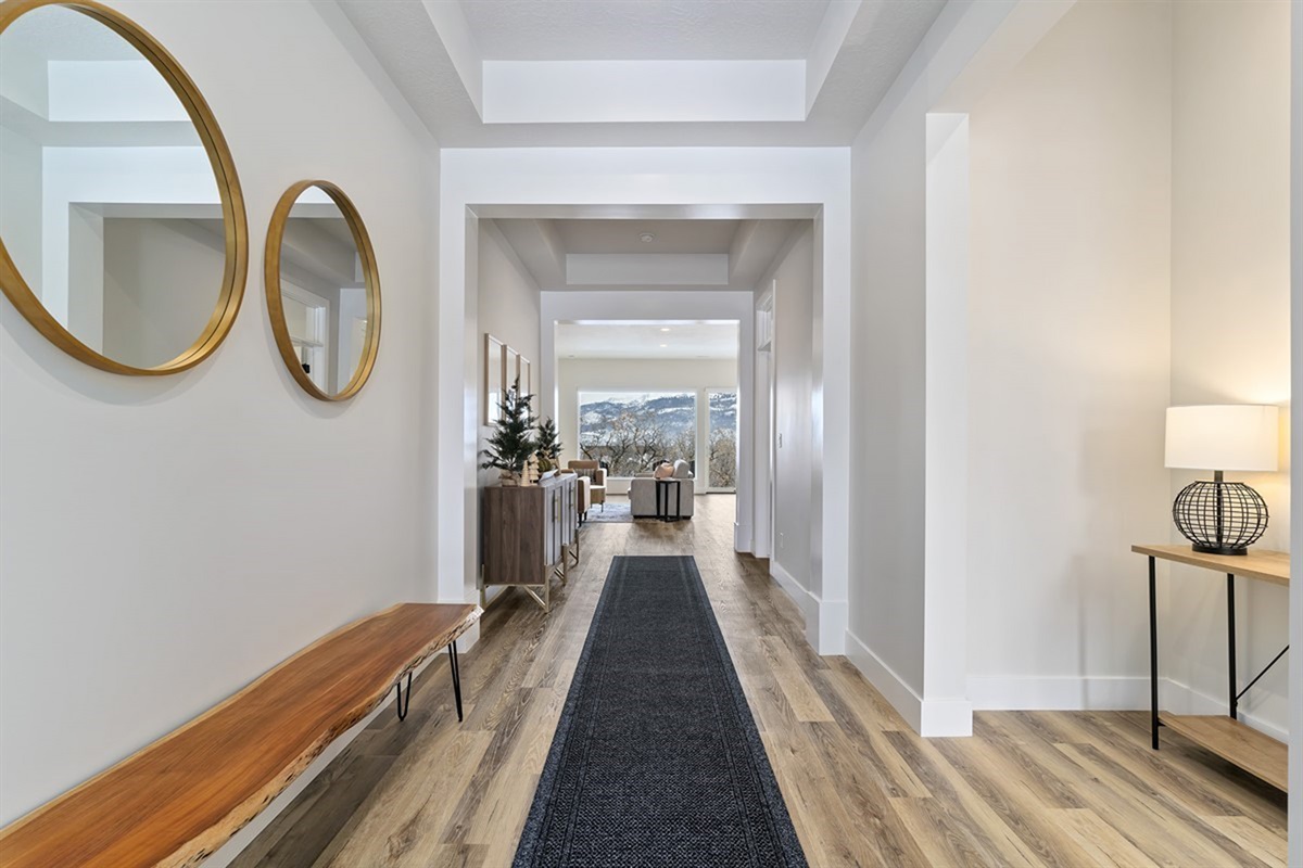 A clean, modern hallway that leads you through the home with a bright, open feel.