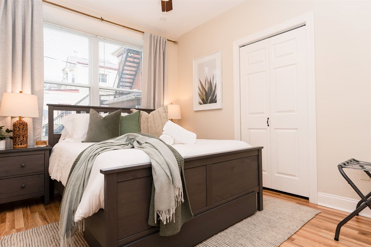 Queen-sized bed with a window, providing a bright and comfortable space to relax.