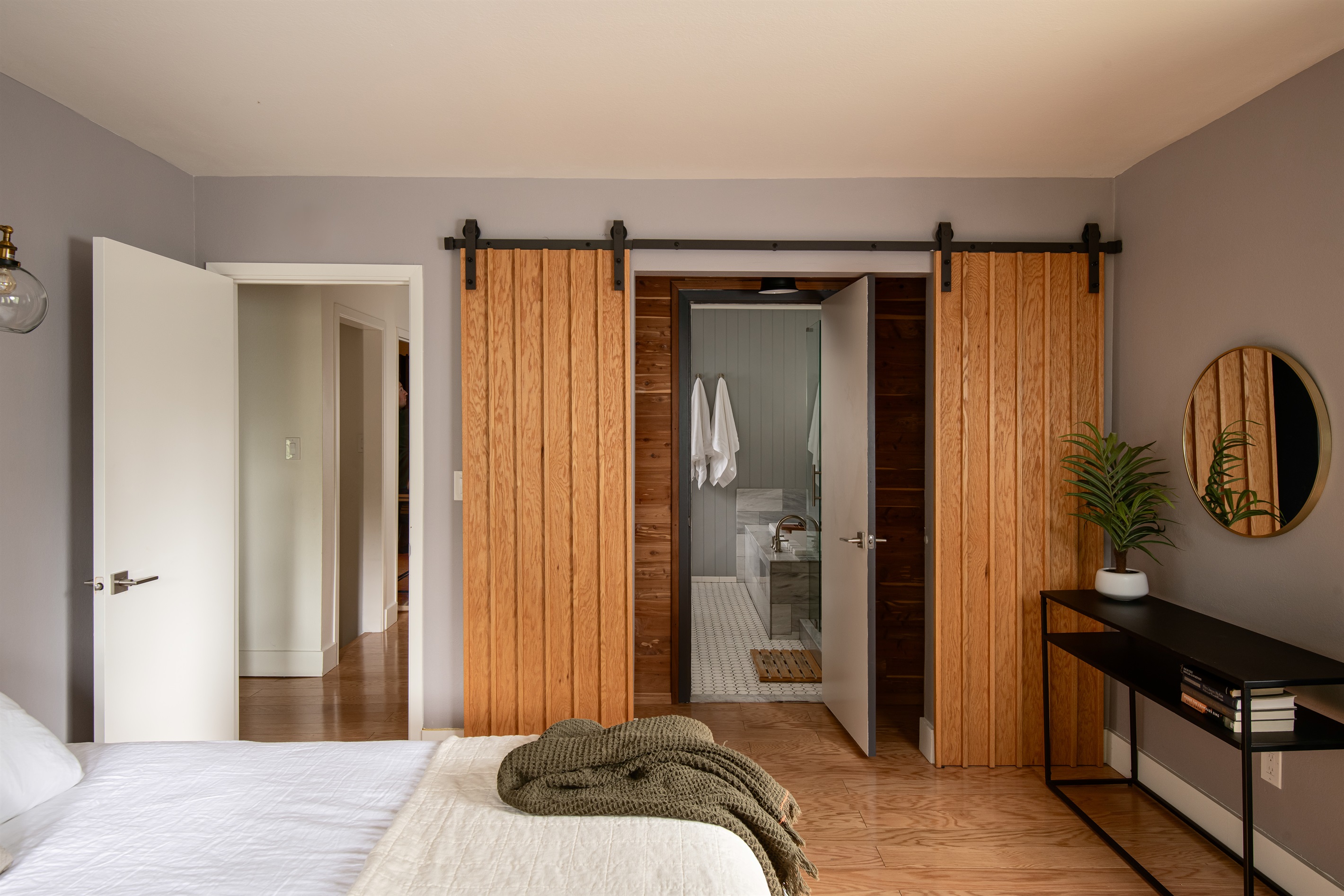 Bedroom with en-suite bathroom and sliding barn doors—private, comfortable space designed for a relaxing Lake Arrowhead cabin stay.