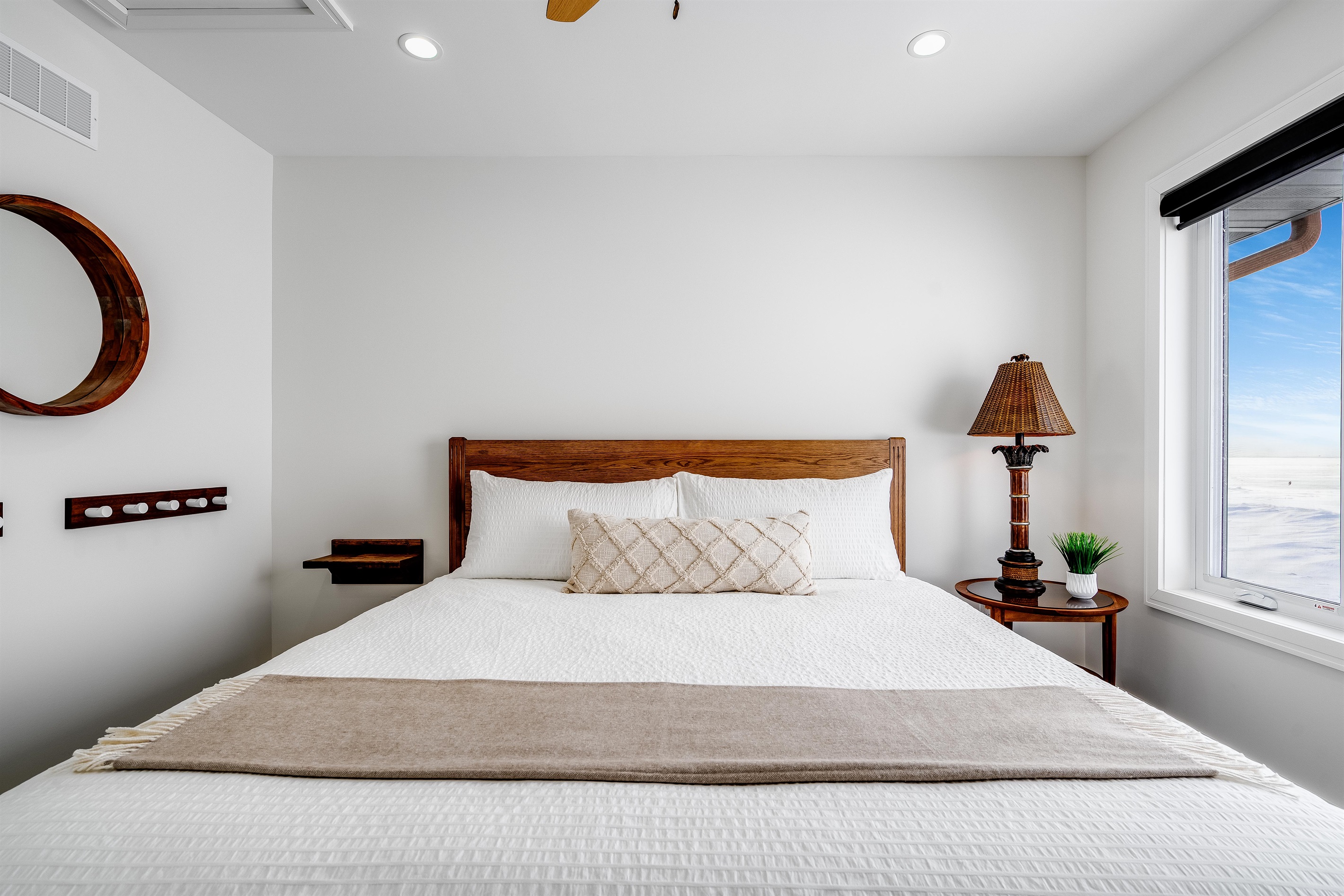 King Bedroom with Natural wood bed frame grounds the space.