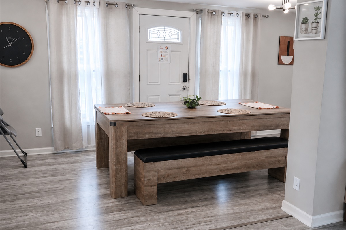 Spacious dining/pool table seats 8 and easily connects to the backyard