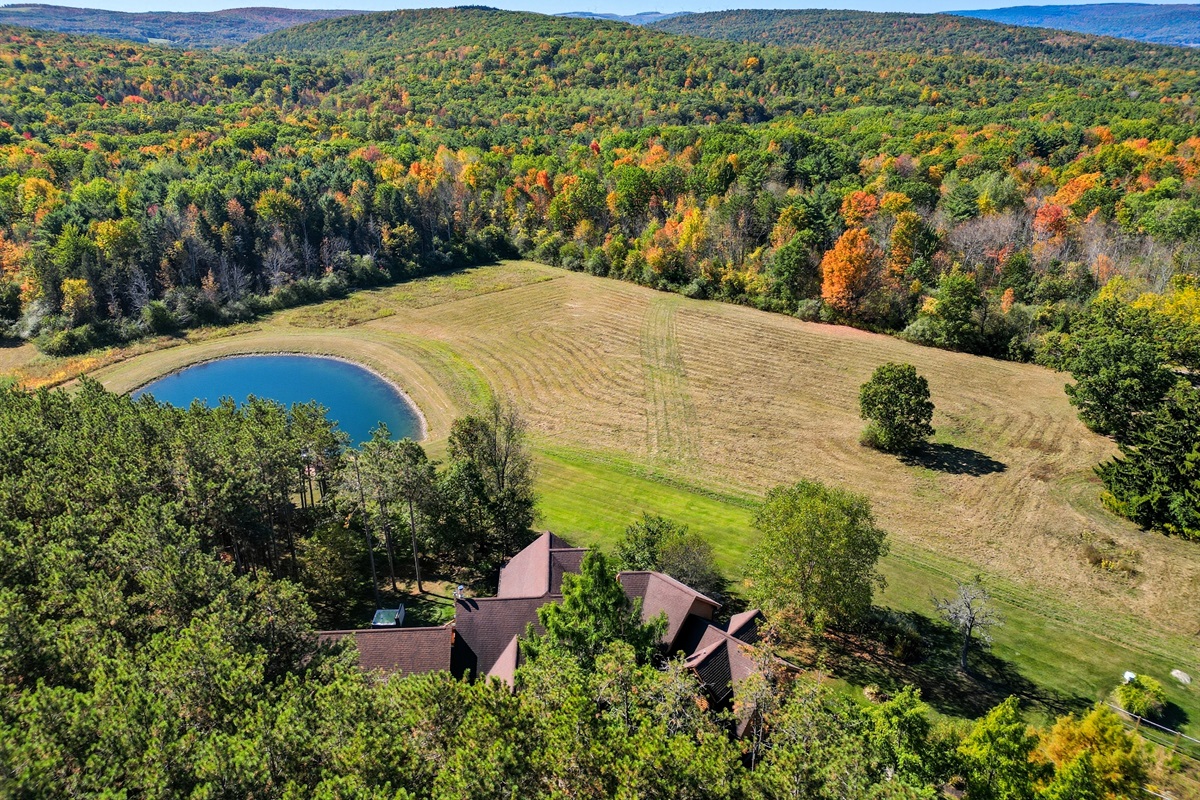 Escape to your own private retreat surrounded by rolling hills and forest. This stunning property features a spring-fed pond with a dock, wide-open meadows, and total privacy—perfect for relax