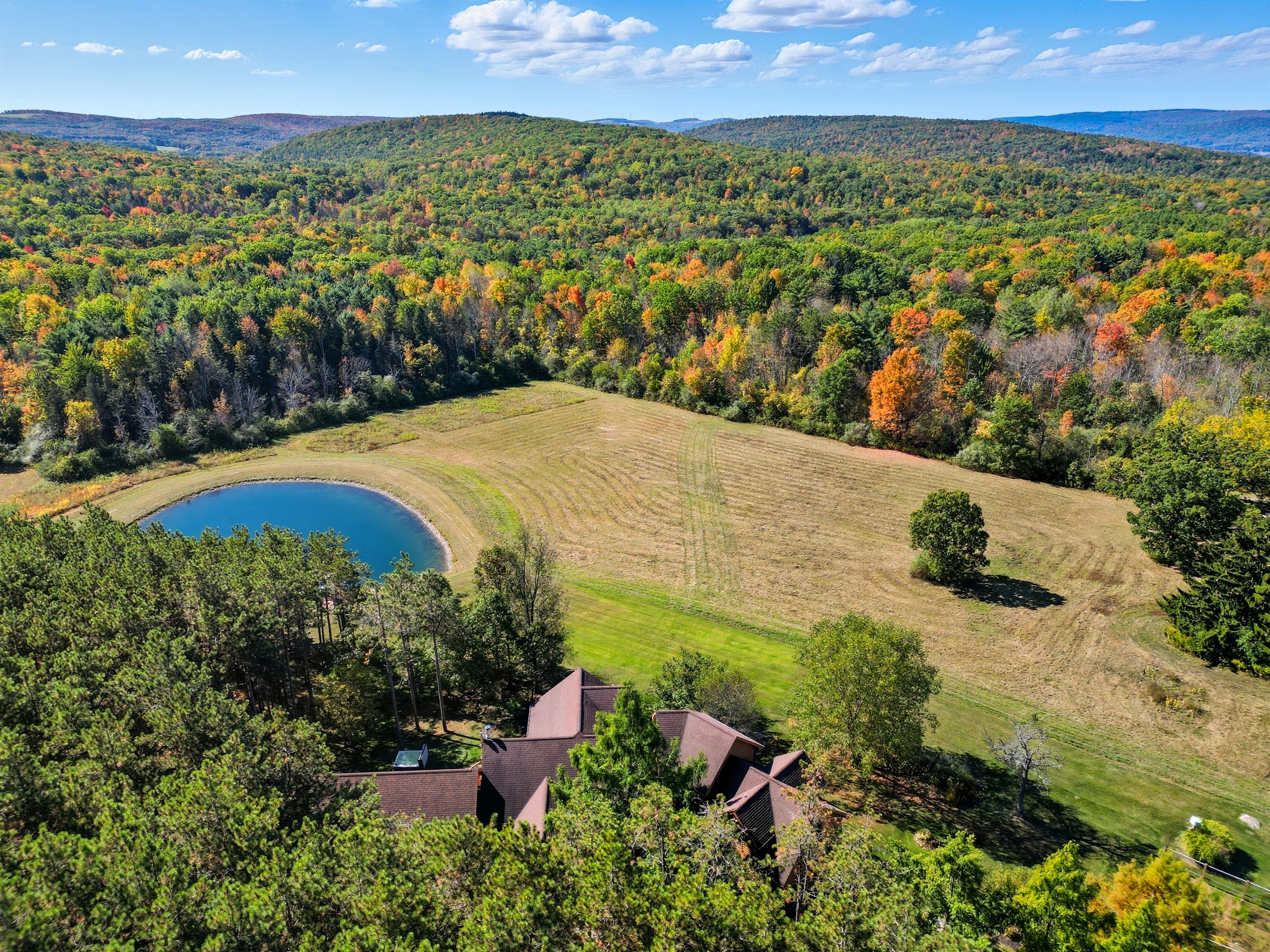 Escape to your own private retreat surrounded by rolling hills and forest. This stunning property features a spring-fed pond with a dock, wide-open meadows, and total privacy—perfect for relax
