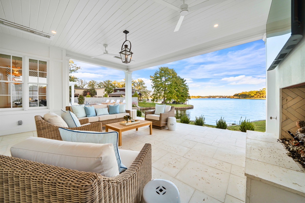 Pool deck with sun loungers and serene views of the water.