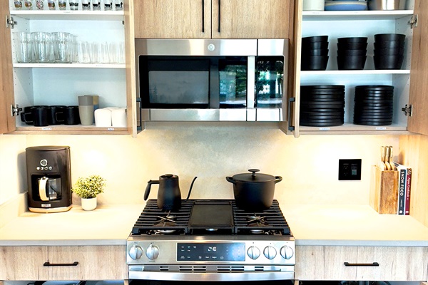 Cabinets open showing ample dining ware