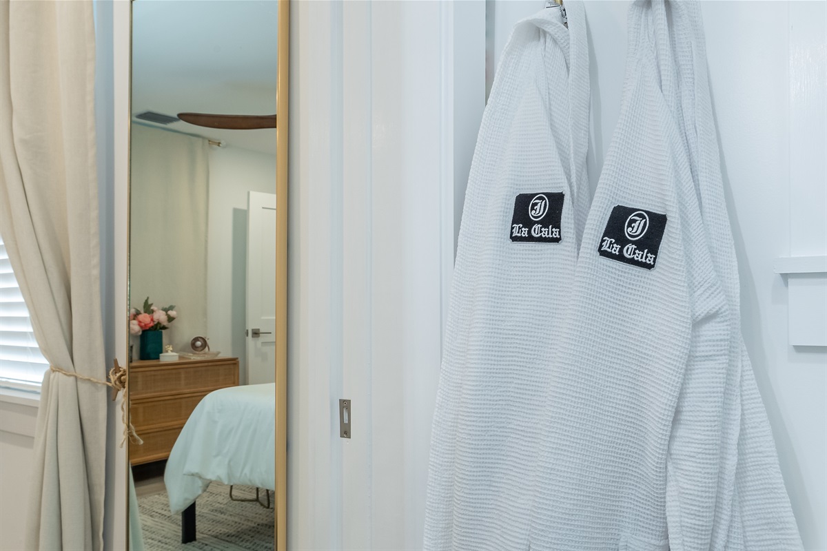 Bathroom Retreat: Indulge in luxury with plush robes and a stylish mirror for your pampering rituals!