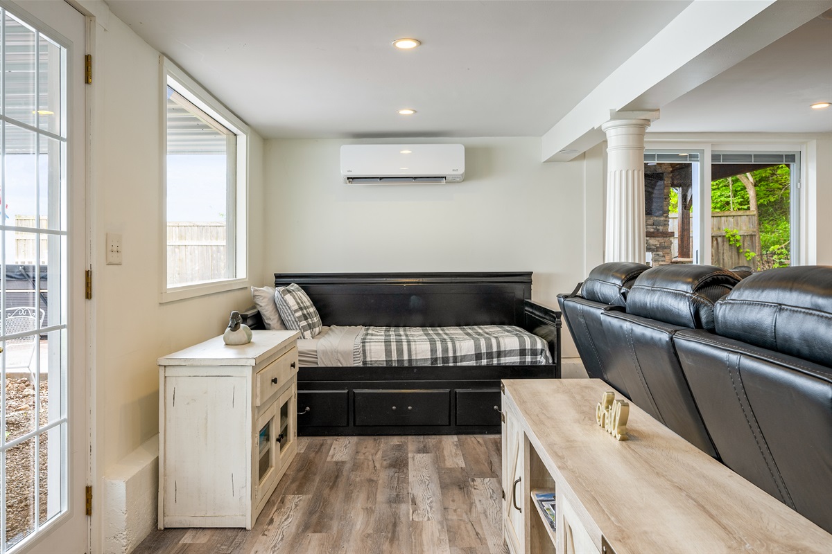 Bright and cozy living space with a stylish daybed and large windows letting in plenty of natural light 🌞🛏️🪟