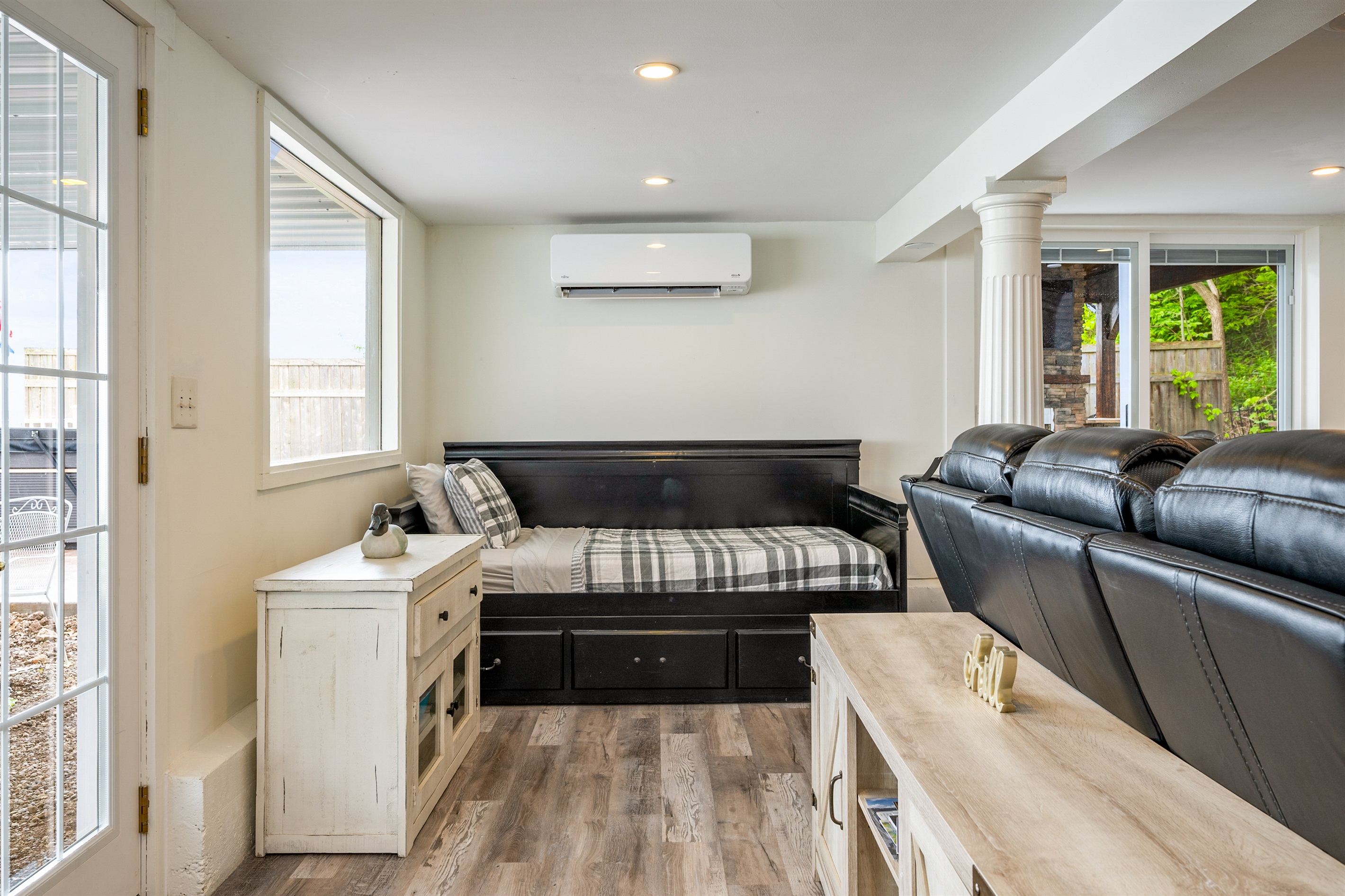 Bright and cozy living space with a stylish daybed and large windows letting in plenty of natural light 🌞🛏️🪟