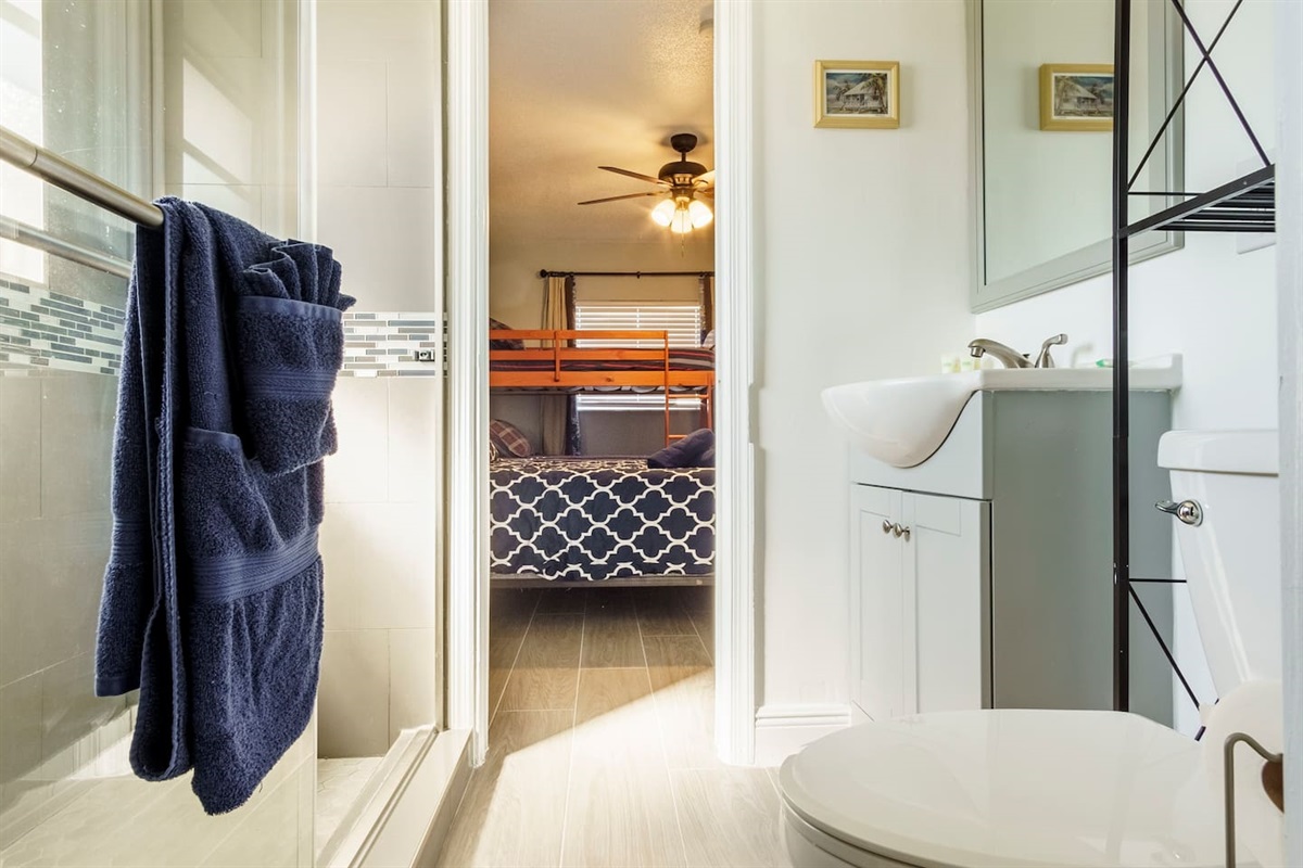 "Jack and Jill" Bathroom with shower and plenty of storage space.