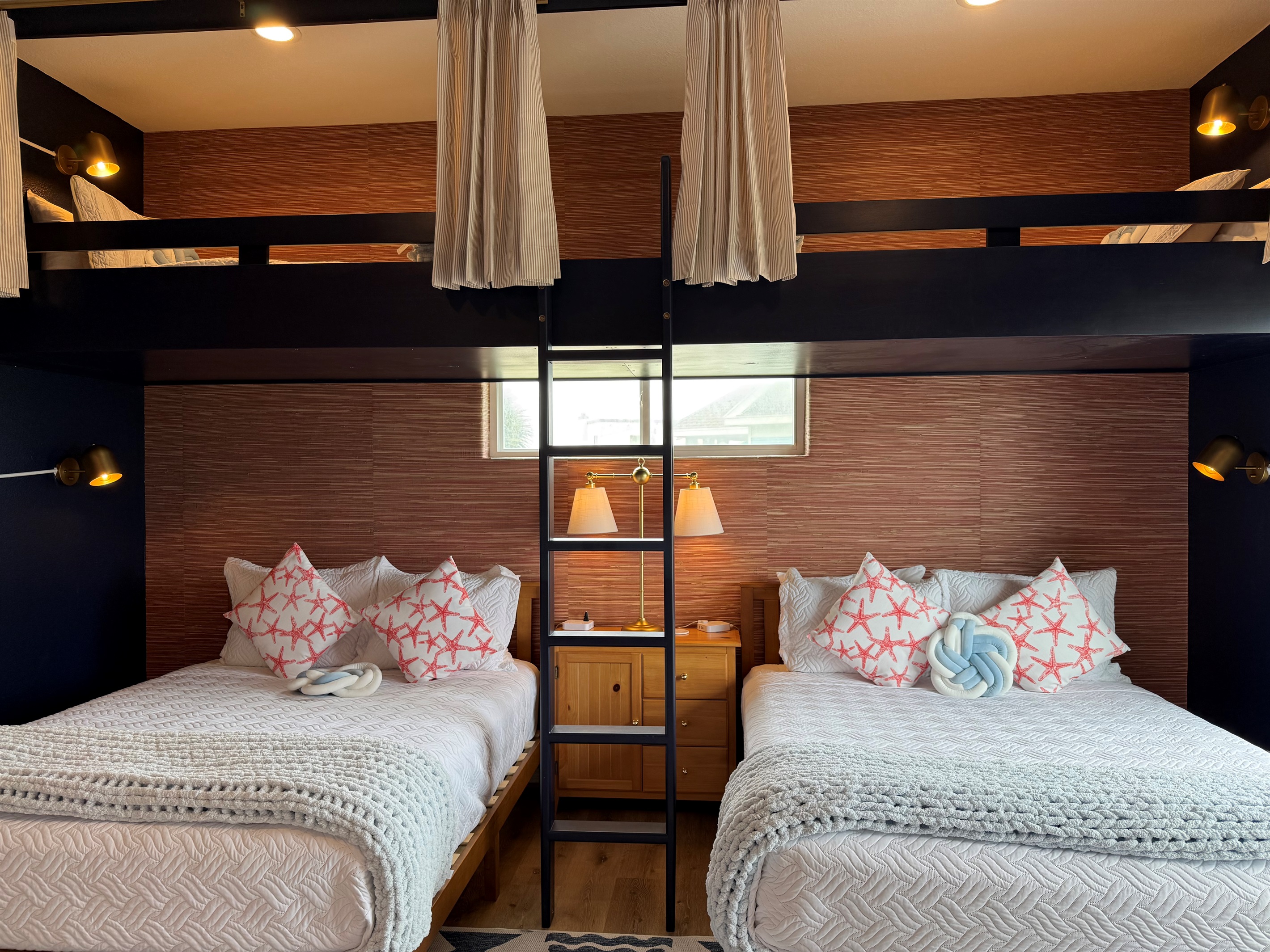 The Fishing Pier sleeps 6. Two Queens on the bottom and above are extra long twins. Pull the curtains for privacy up top!  Each bed has its own reading lamp also. 