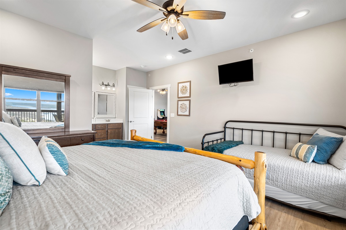 Upper level king bedroom 5 with twin bed, trundle, and en suite shower