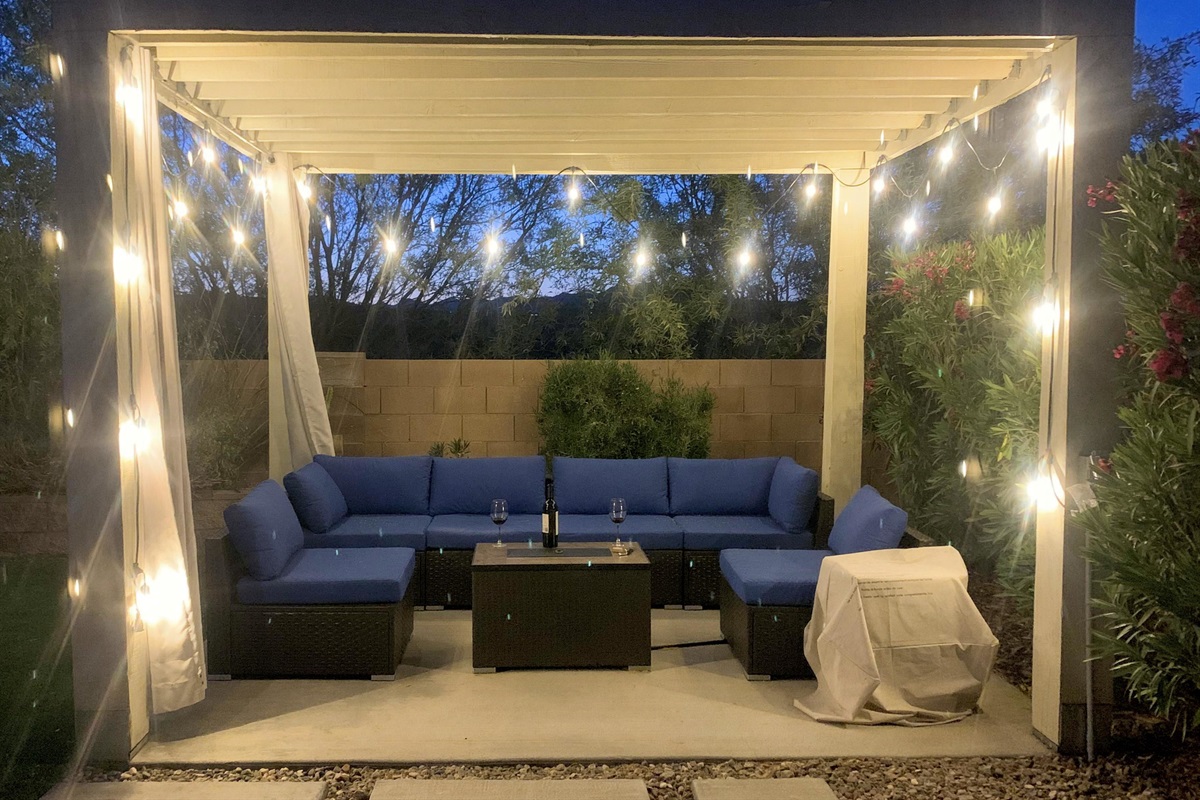 Relax with a bottle of wine under the pergola. When it's cool the firepit table keeps things cozy.