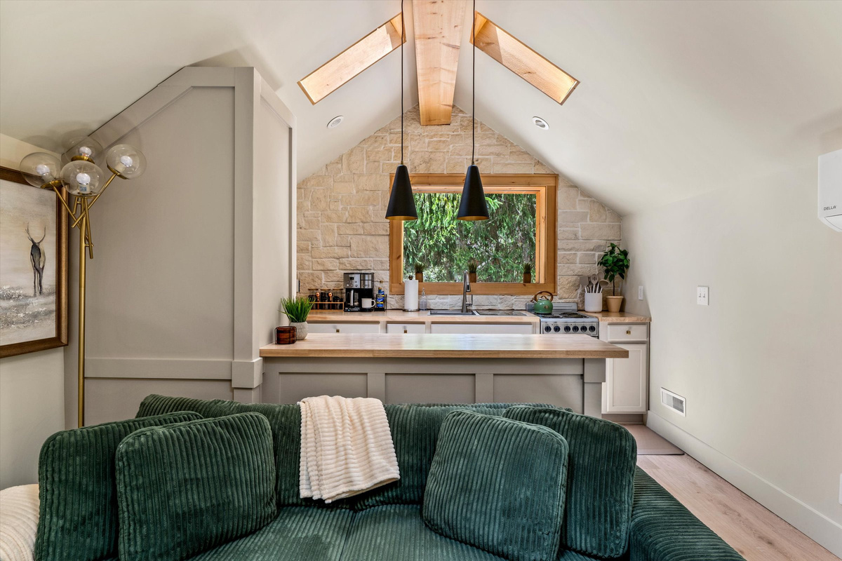 The Penthouse: Cozy Living Room with 55-inch Smart TV, Fireplace, and bistro table.