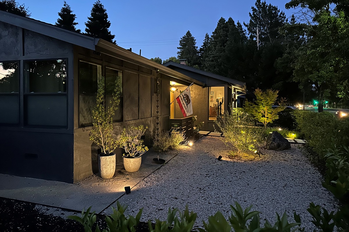 As the sun sets, the property transforms into a warm and inviting retreat with elegant outdoor lighting that creates the perfect ambiance for evening gatherings, outdoor dining, and relaxing under the stars.