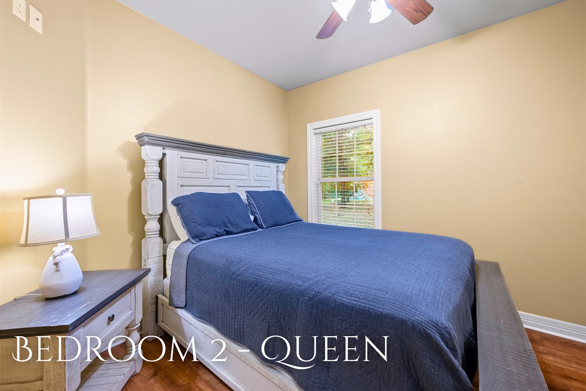 Bedroom 2 featuring a queen bed and natural light.