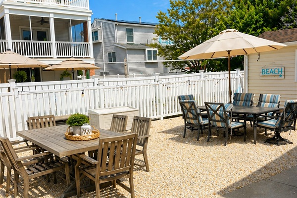 Spacious backyard featuring plenty of outdoor furniture, a hammock, gas grill, clothesline, and outdoor showers.
