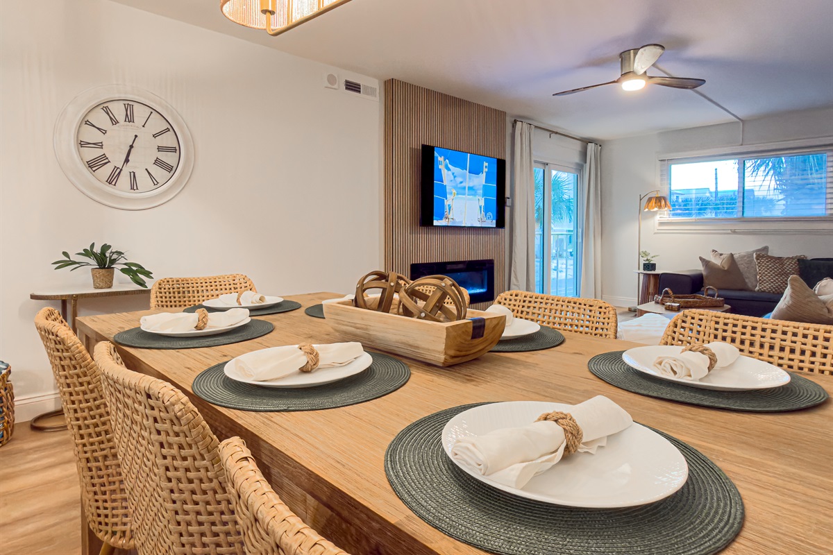 Turn on the dining room light for a cozy evening meal. The warm tones make the space feel incredibly welcoming. Three extra guests can sit at the kitchen counter nearby. This makes serving large groups simple and fun.