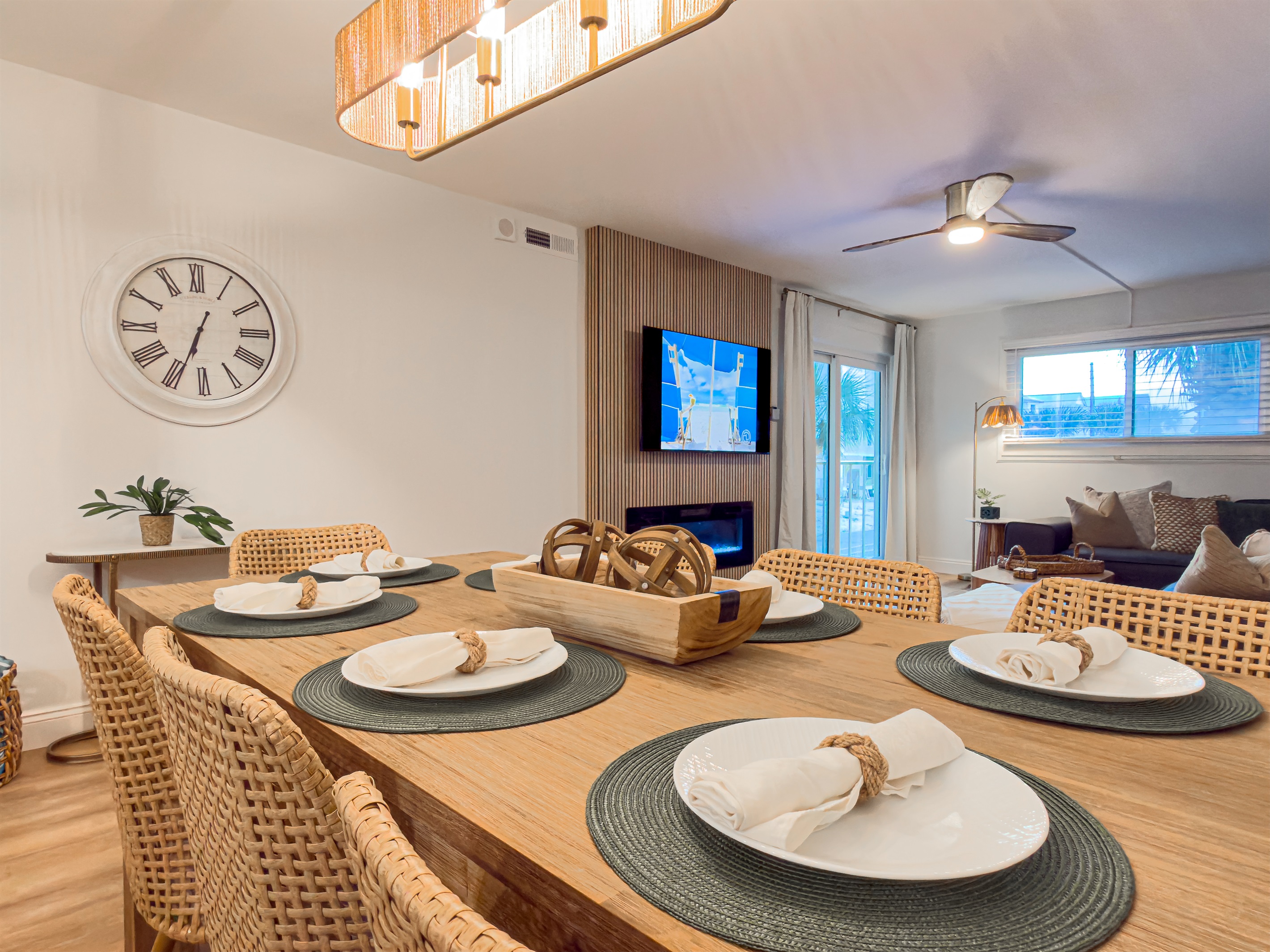 Turn on the dining room light for a cozy evening meal. The warm tones make the space feel incredibly welcoming. Three extra guests can sit at the kitchen counter nearby. This makes serving large groups simple and fun.