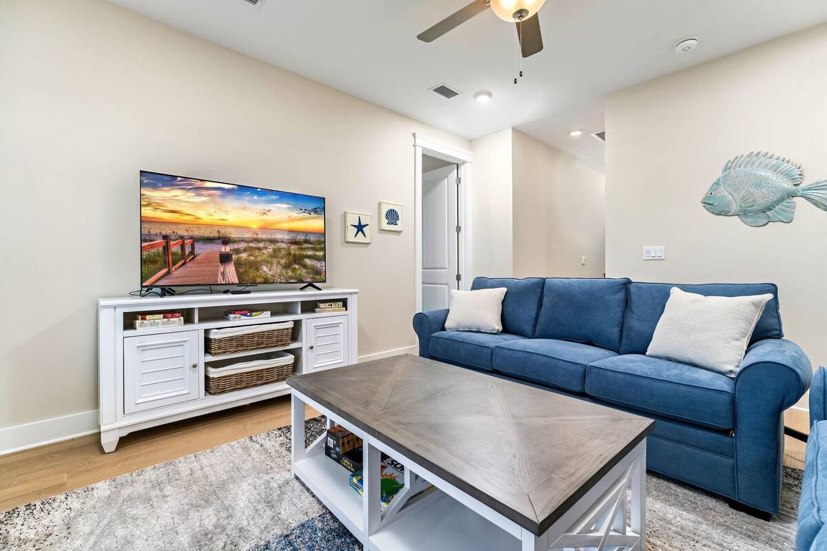 The second-floor living area offers balcony access with breathtaking Gulf views and a queen sleeper sofa, ideal for extra guests or relaxing with the sea breeze.