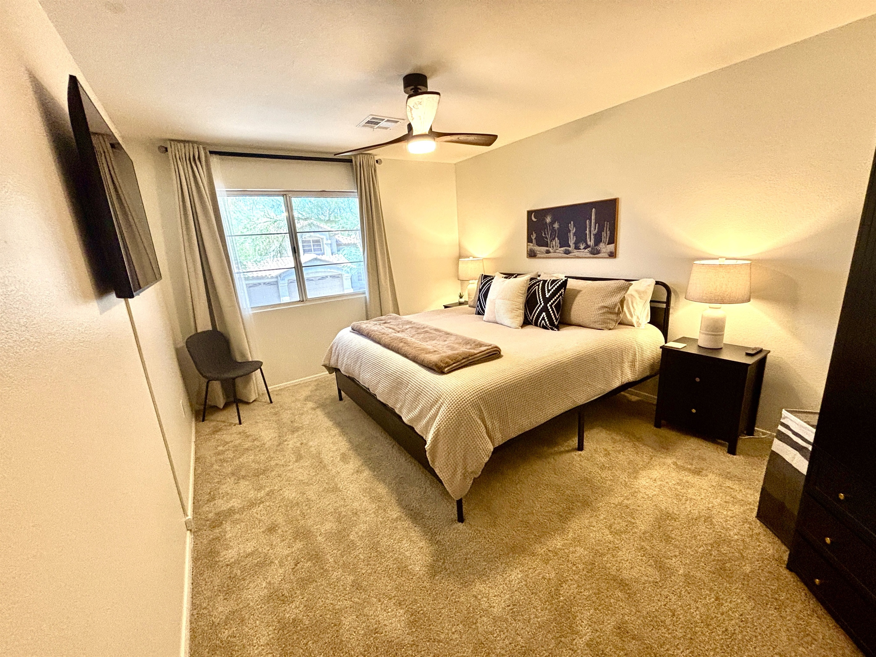King bedroom upstairs with 55" Smart TV, Blackout curtains and ceiling fan