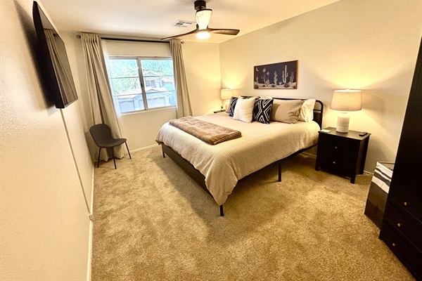 King bedroom upstairs with 55" Smart TV, Blackout curtains and ceiling fan