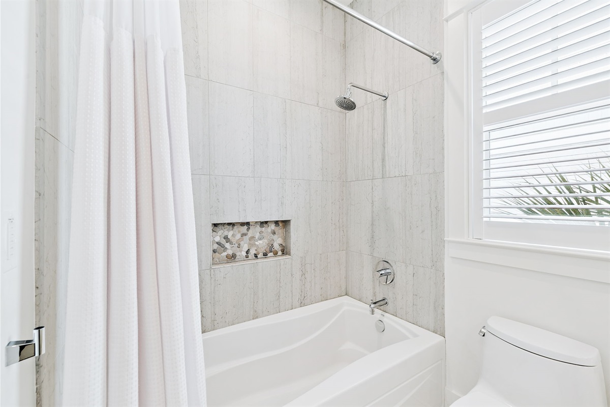 Second- floor bathroom features double vanities and a tub/shower combo