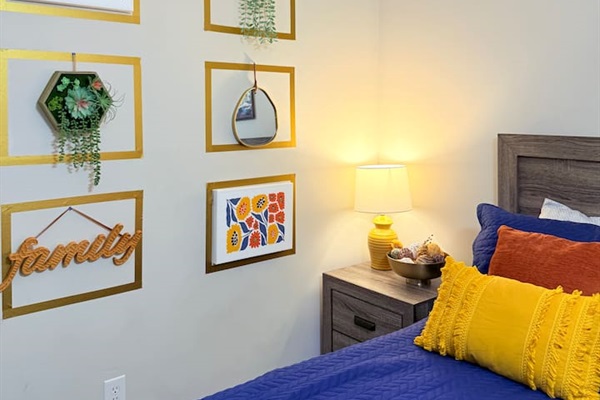 Cozy bedside setup with modern decor and soft textures — designed for a restful stay with upscale comfort. 