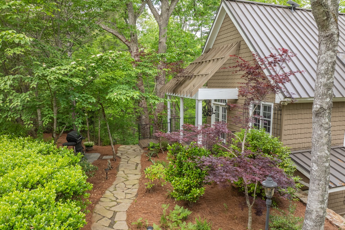 Mature trees, lush landscaping, and inviting outdoor spaces create a serene mountain setting from the moment you arrive.