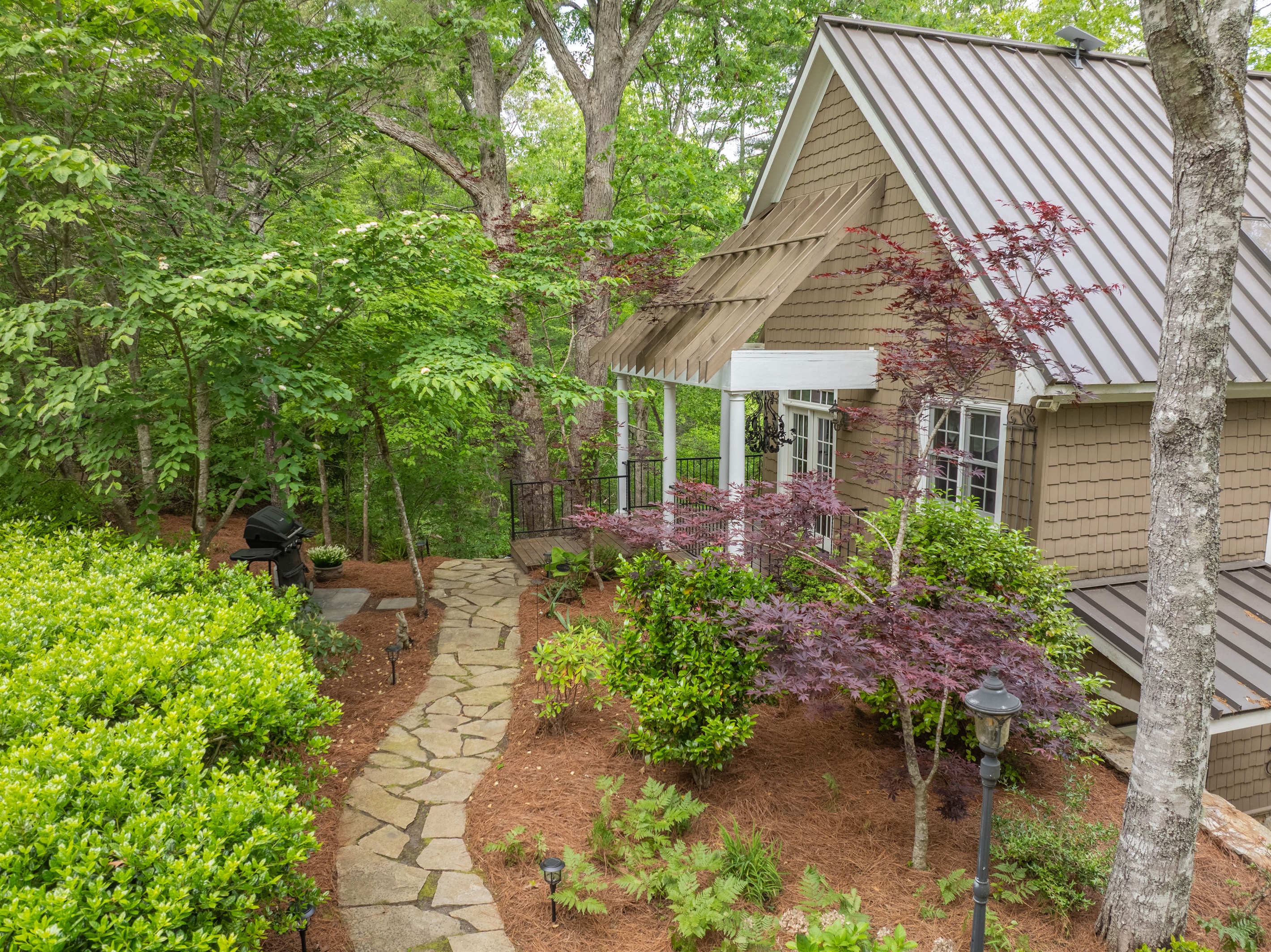 Mature trees, lush landscaping, and inviting outdoor spaces create a serene mountain setting from the moment you arrive.