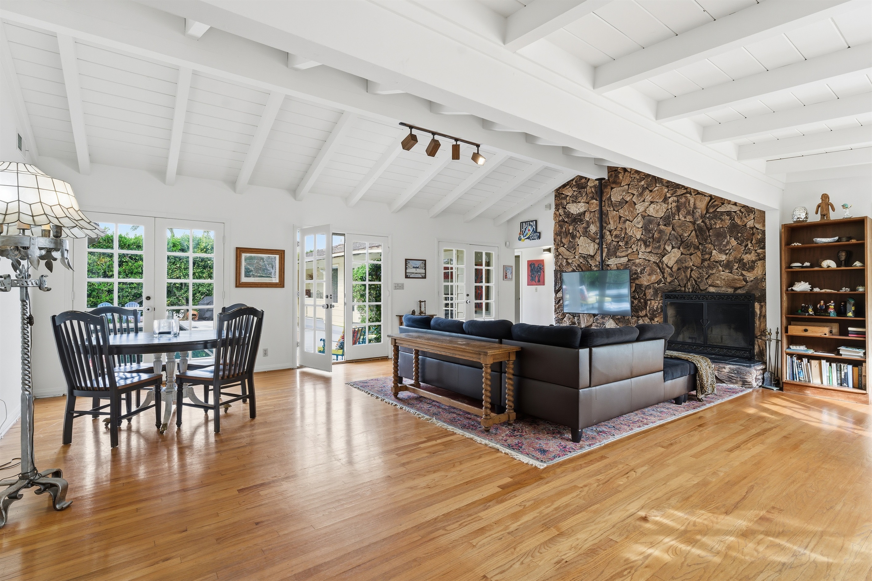 Large living room with a view of the pool in the backyard, and the courtyard in the front.