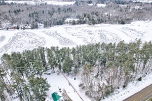 Aerial view of the entire property during winter in Maine. Lakeside on Toddy Pond