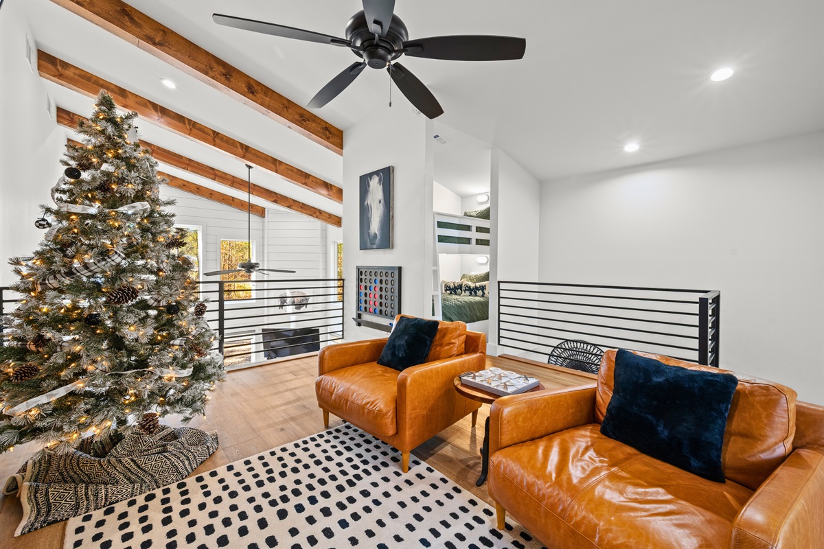 Comfortable seating in the loft makes it an easy place to unwind while still feeling connected to the rest of the cabin.