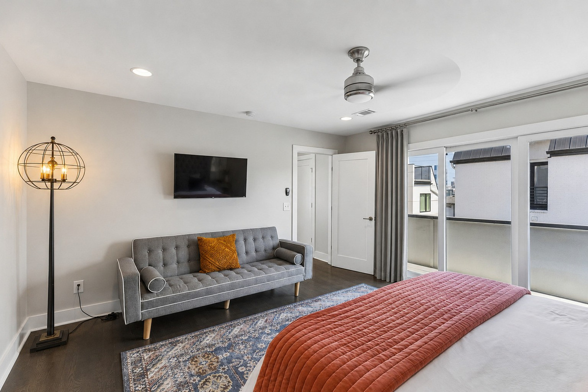 Claim the king bedroom and you get your own sofa, wall TV, and private bath &mdash; no sharing required for whoever stays in here.