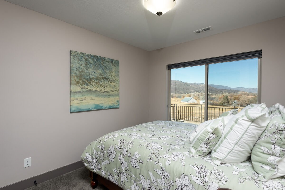 Cozy queen bedroom filled with natural light.